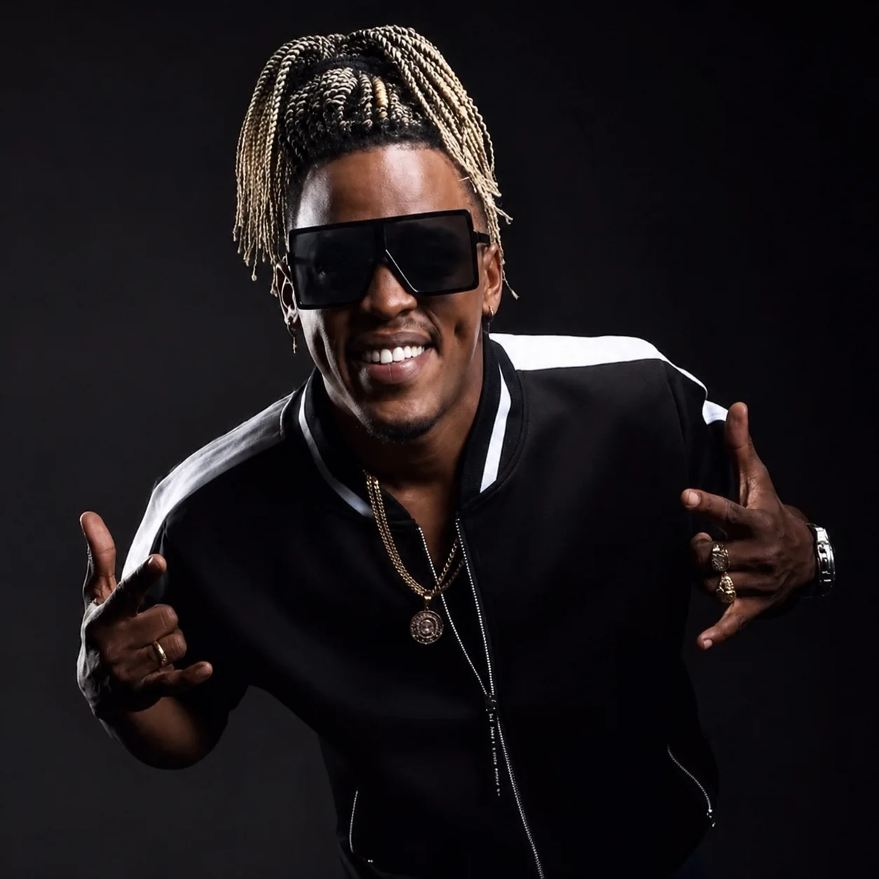 Mucho Birbo wearing sunglasses in a black jacket