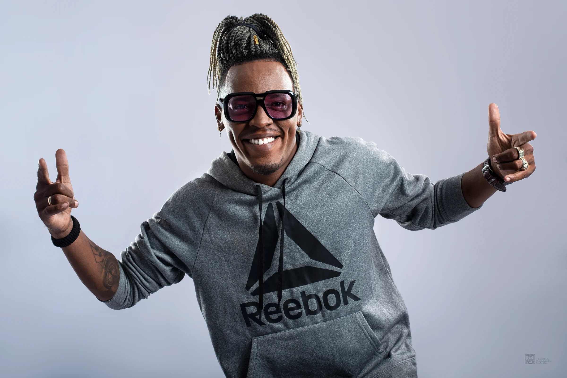 Mucho Birbo smiling in studio portrait